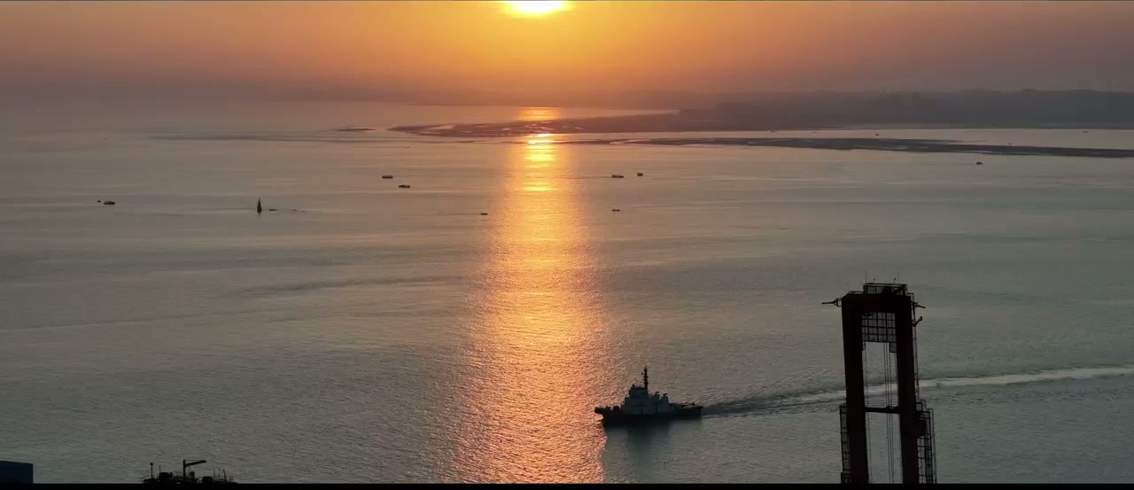 海上日出与打桩船